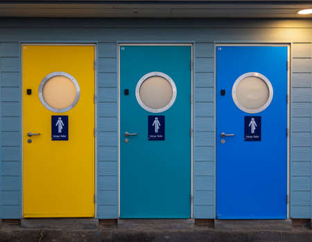 Unisex public toilet doors on the seafront at Weymouth in Dorset on the South Coast of England UKの写真素材
