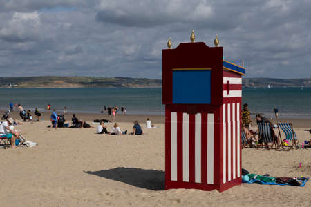 Editorial Weymouth, UK - September 11th, 2021:A Summer scene on Weymouth Beach in England featuring a Punch and Judy booth.のeditorial素材
