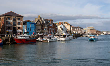 Editorial Weymouth, UK - September 11th, 2021: Working fishing boats moored up at Custom House Quay in Weymouth, England UKのeditorial素材