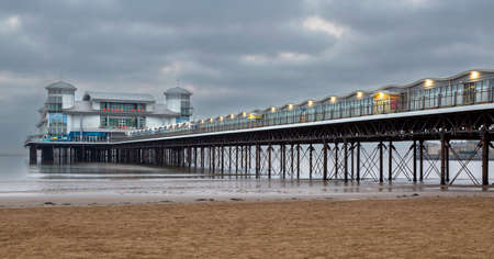 Editorial Western-super-mare; UK - April 18, 2022: The Grand Pier on the beach at Western-super-Mare in North Somerset, England UKのeditorial素材