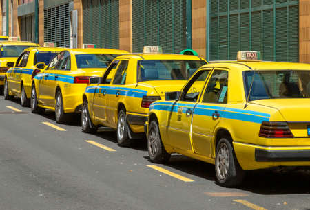 Editorial Madeira, Portugal - March 28, 2022: A row of yellow taxi cabs on the island of Funchal in Madeira, Portugalのeditorial素材