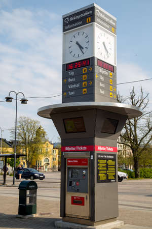 Clock and ticket dispenser at the central station in Karlskrona, Blekinge, Sweden.のeditorial素材