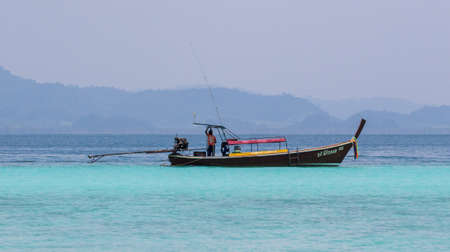 Longtail boat in the Andaman Sea off the small island of Koh Kradan in southern Thailand.のeditorial素材