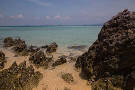 Rocky beach by the Andaman Sea on the small island of Koh Kradan in southern Thailand.の写真素材
