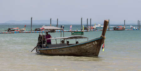 Longtail boats and motorboat at East Railay Beach near Ao Nang in southern Thailand.のeditorial素材