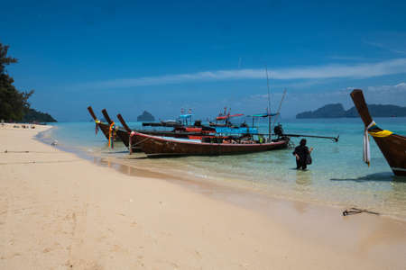 Longtail boats by the sandy beach on the small island of Koh Kradan in southern Thailand.のeditorial素材