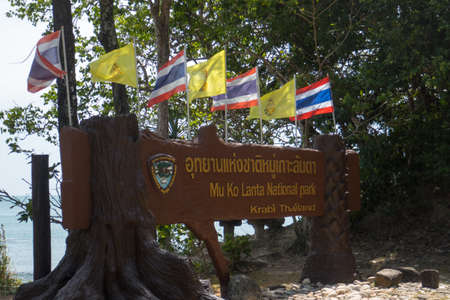 Flags at the entrance to Mu Koh Lanta National Park, on the southernmost part of Koh Lanta island in southern Thailand.のeditorial素材