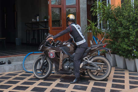 Policeman on motorcycle in Saladan on Koh Lanta island in southern Thailand.のeditorial素材