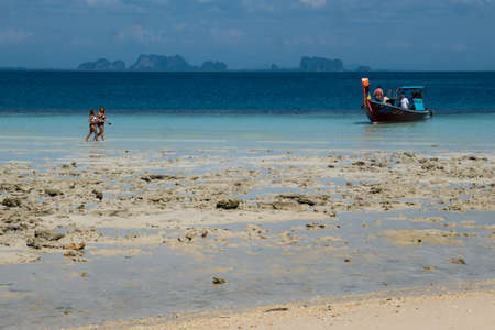 Beach with people and longtail boat on the small island of Koh Kradan in southern Thailand.のeditorial素材
