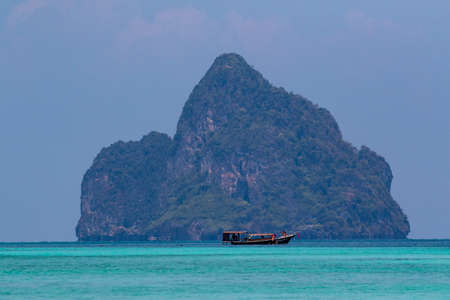 Longtail boat with snorkelers, off the island of Koh Kradan in southern Thailand.の写真素材