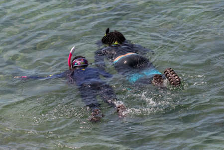 Snorkelers in the Andaman Sea, off the island of Koh Lanta in southern Thailand.