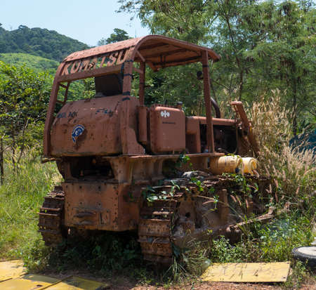 Old and overgrown bulldozer on the island of Koh Lanta in southern Thailand.のeditorial素材
