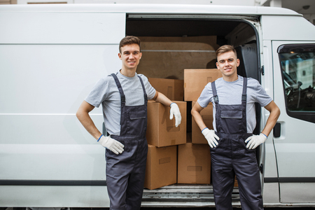 Two young handsome smiling workers wearing uniforms are standingの写真素材