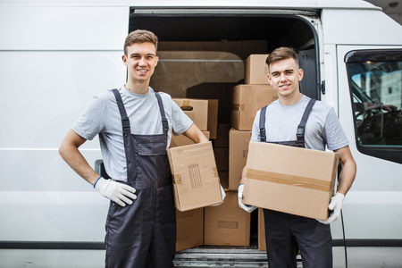 Two young handsome smiling workers wearing uniforms are standingの写真素材