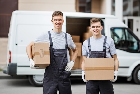 Two young handsome smiling workers wearing uniforms are standingの写真素材