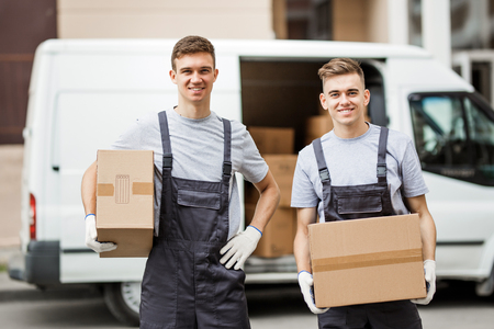 Two young handsome smiling workers wearing uniforms are standingの写真素材