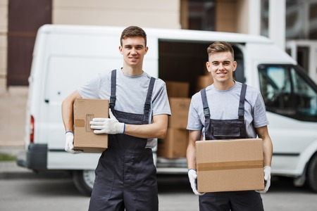 Two young handsome smiling workers wearing uniforms are standingの写真素材