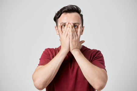 Embarrassed guy dressed in burgundyの写真素材