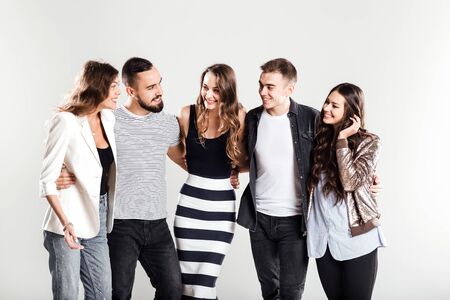 Ð¡ompany of girls and guys in fashionable  casual clothes talk on a white background in the studioの写真素材