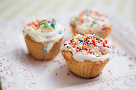 Small Easter cakes are  on the plate on the table in the light kitchen