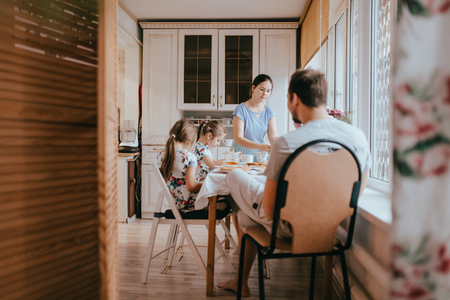 Family breakfast at home in the nice cozy kitchenの写真素材