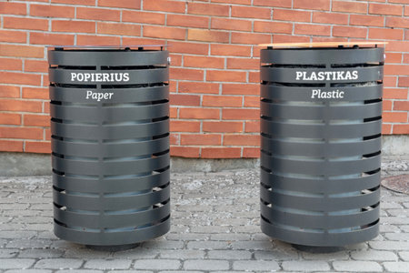 paper and plastic waste bins on street.の写真素材