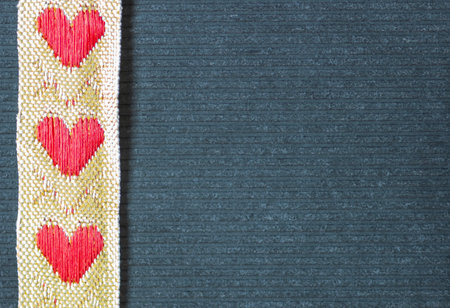 heart ribbon on the grey background .