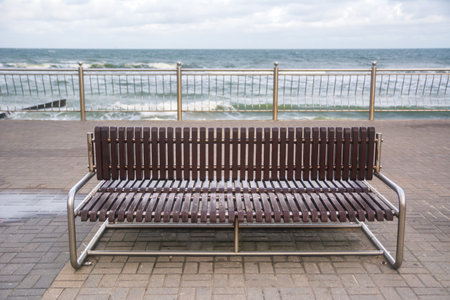 Brown bench at the beach of Zelenogradsk, Russia.
