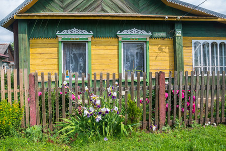 The facade of the old wooden houses with carved architraves, Belarus.の写真素材