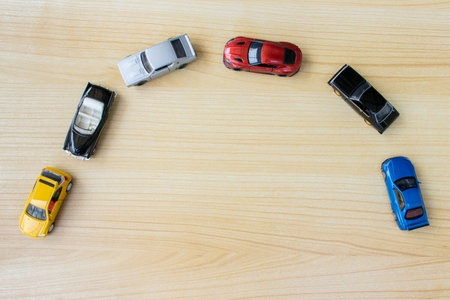 Group of toy cars isolated on wooden background, after some edits.