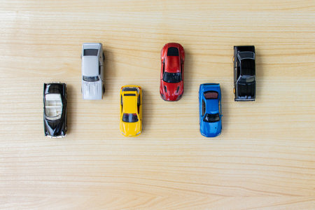 Group of toy cars isolated on wooden background, after some edits.の写真素材