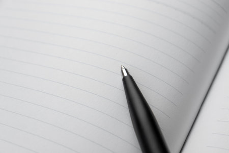 A pen placed on opened page of a book. After some edits.の写真素材