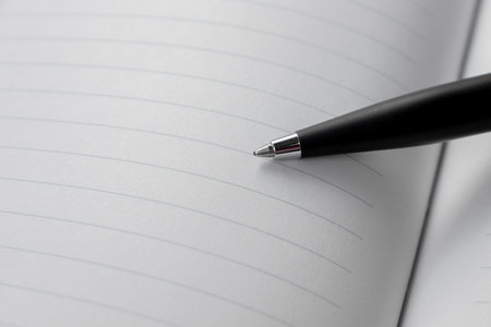 A pen placed on opened page of a book. After some edits.の写真素材