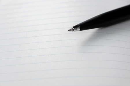 A pen placed on opened page of a book. After some edits.の写真素材