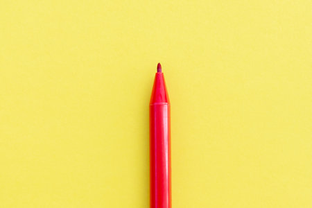 Red marker isolated on yellow background, after some edits.の写真素材