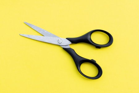 Scissors isolated on yellow  background, after some edits.の写真素材