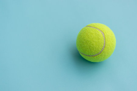 Tennis ball isolated on blue background with copy space for text. After some edits.の写真素材