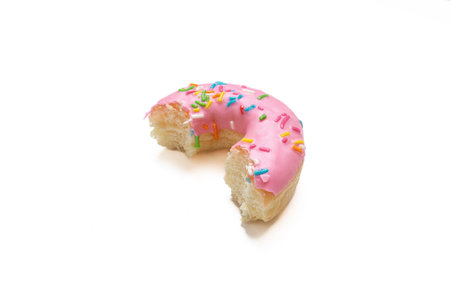 Edited photo. Messy strawberry doughnut isolated on white background.の写真素材