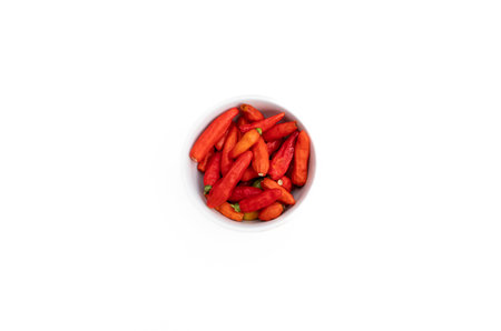 Red chilli in a bowl isolated on white background. After some edits.の写真素材