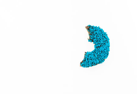 Donut with blue sprinkles isolated on white background. After some edits.の写真素材