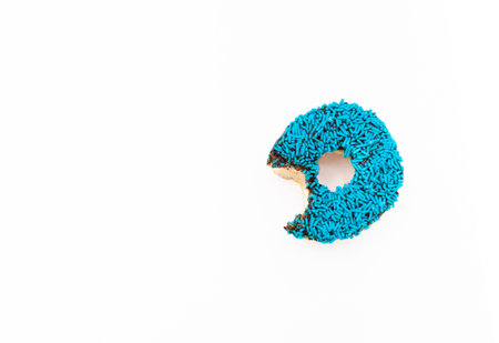 Donut with blue sprinkles isolated on white background. After some edits.の写真素材