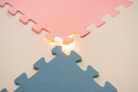 Concept for teamwork or mystery stuff. Jigsaw puzzle with a glowing light. After some edits.の写真素材