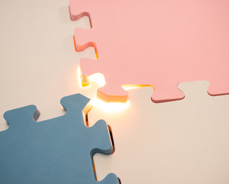 Concept for teamwork or mystery stuff. Jigsaw puzzle with a glowing light. After some edits.の写真素材