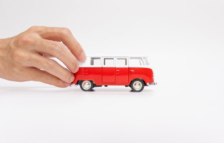 Hand holding a toy car isolated on white background. After some edits.の写真素材