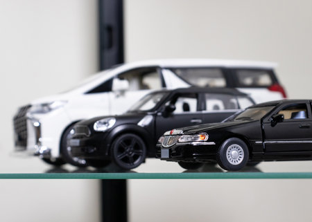Selective focus. toy cars placed on glass shelf. After some edits.の写真素材