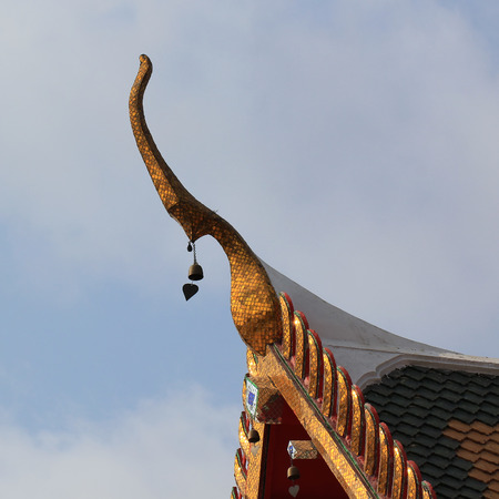 gable apex on temple roof with blue sky 
