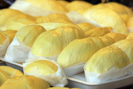 peeled delicious durian fruit on market tray