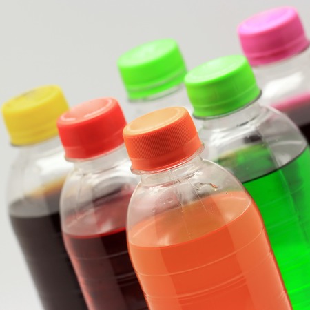 colorful of soft drink bottles on isolated background