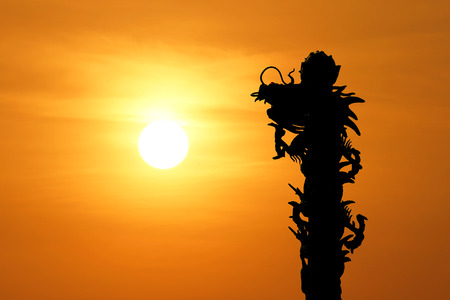 silhouette of  chinese dragon with beautiful sunset backgroundの写真素材