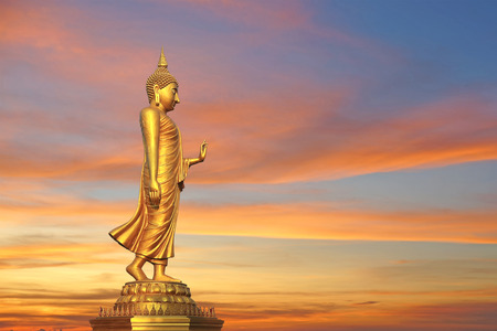 golden buddha image with beautiful twilight backgroundの写真素材